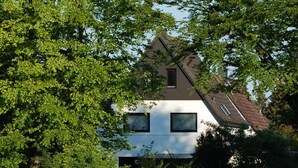 A house surrounded by trees and a field.