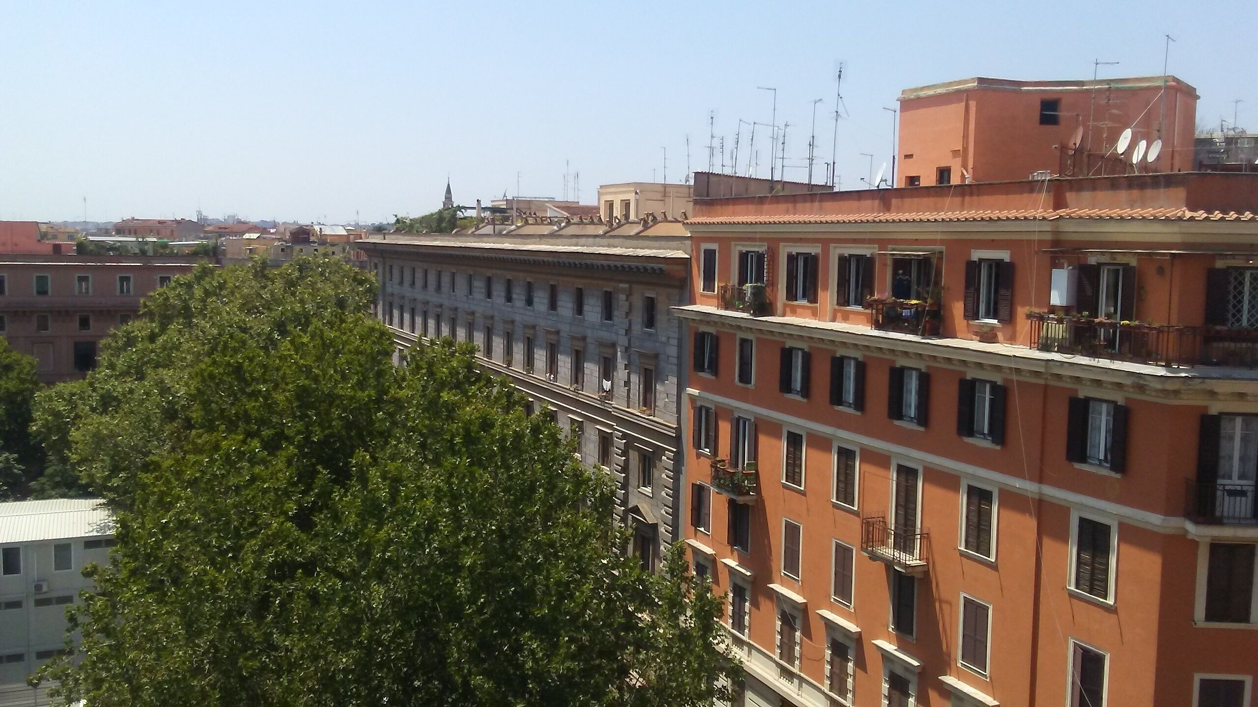 A multi-story building with balconies and a clear view of the surrounding area.