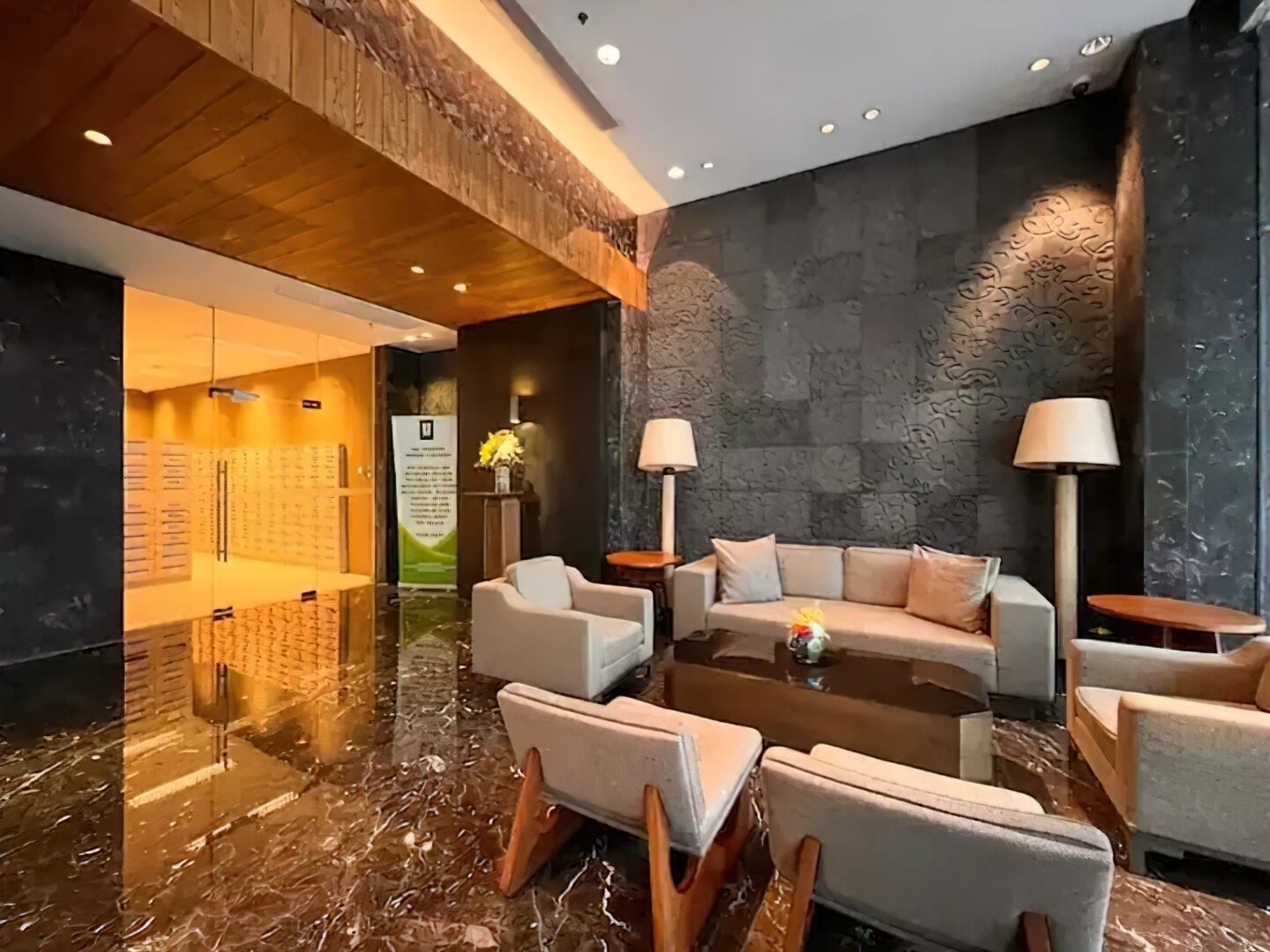 A modern lobby with a marble floor, a sofa set, and a coffee table.