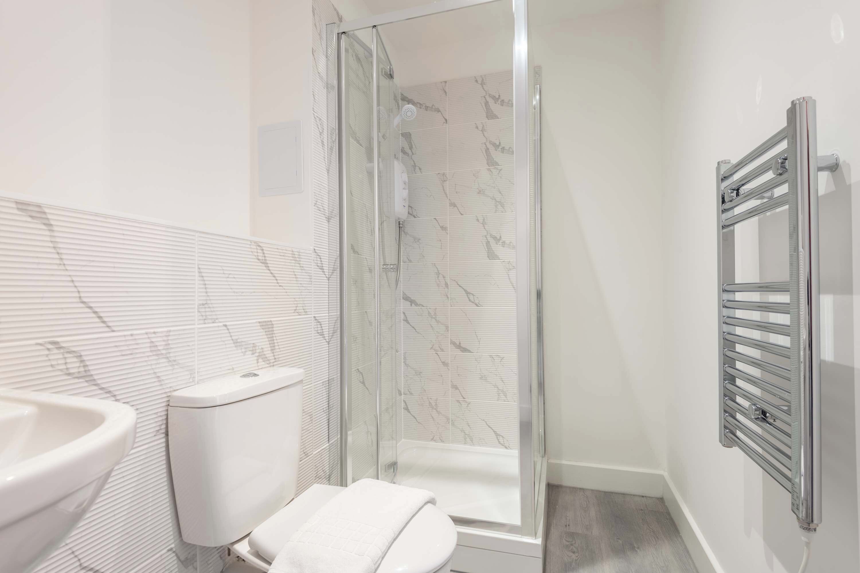 Shower, hair dryer, towels, shampoo