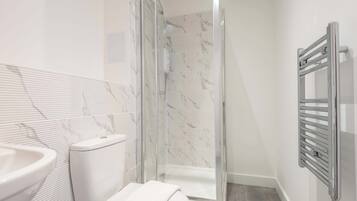Shower, hair dryer, towels, shampoo