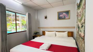 Deluxe Double Room, Patio, Pool View | In-room safe, blackout drapes, soundproofing, iron/ironing board