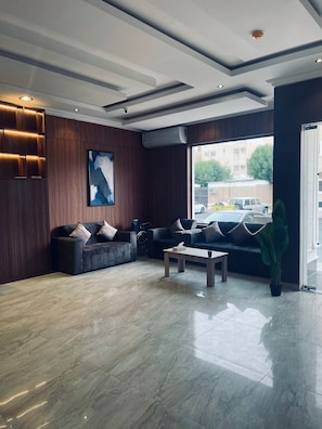 Relax in a stylish seating area with a sofa, coffee table, and large window offering a view.