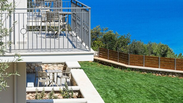 A two-story house with a patio overlooking a body of water and mountains. - Lainas Sea View Lefkada (Lefkada)