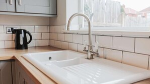 A kitchen with a white sink, a faucet, and a kettle on the counter. - Fabulous 3 bedroom Home in Redcar (Redcar)
