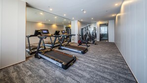 A modern gym with treadmills, exercise bikes, and weight machines. - Lavande Hotel Dongguan Shipai  (Dongguan)