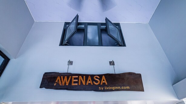 A sign with the name 'Awenasa' and a website address 'by livinginn.com' in a modern interior setting. - Awenasa by Livinginn (Ho Chi Minh City)
