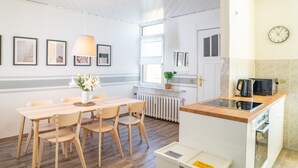 A modern kitchen with a wooden countertop, a built-in oven, and a coffee maker. - Spacious Apartment In Strausberg - Sleeps 6 (Strausberg)