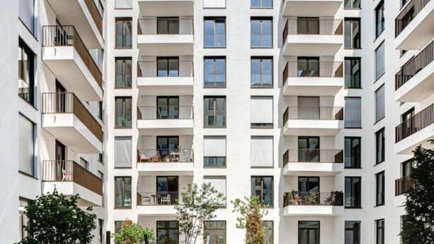 A modern multi-story residential building with balconies, a central courtyard, and a flat roof. - Arbio I Luxury Apartments (Berlin)