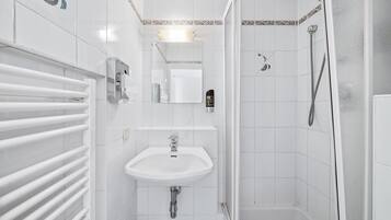 Hair dryer, towels, shampoo, toilet paper
