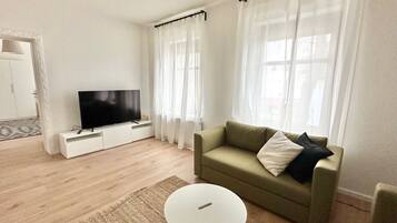 Apartment, 2 Bedrooms (378165) | Living area | 60-inch flat-screen TV with cable channels