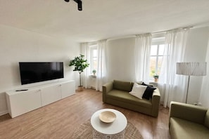 Apartment, 2 Bedrooms (360762) | Living area | 60-inch flat-screen TV with cable channels