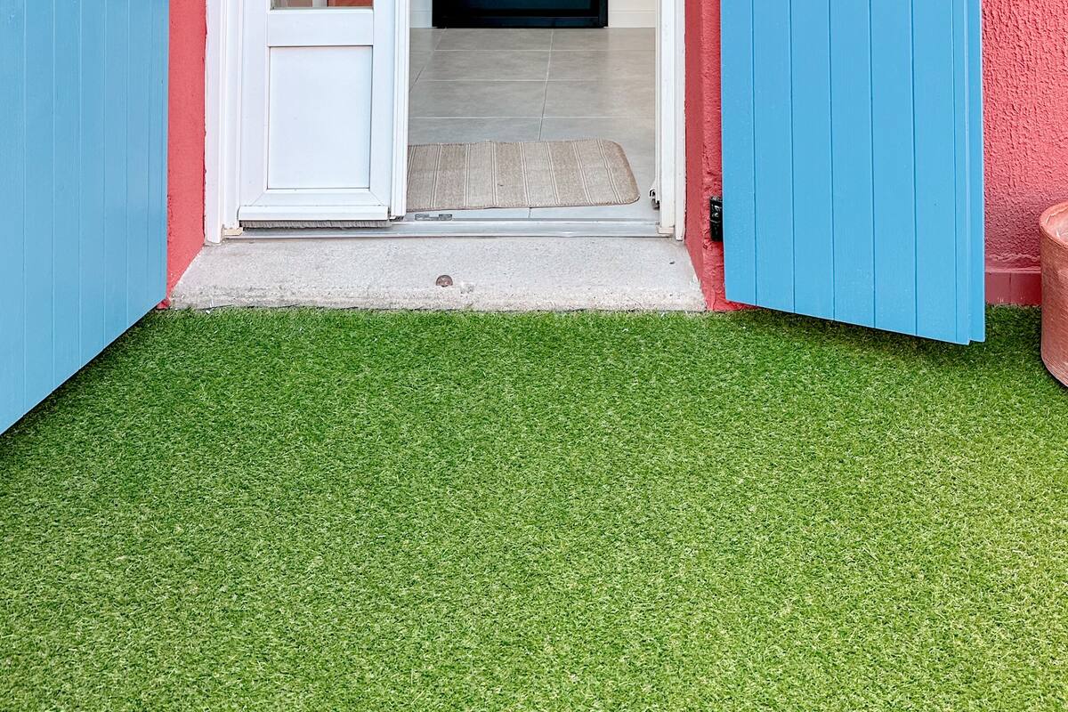 A red and blue house with a white door and a blue door.