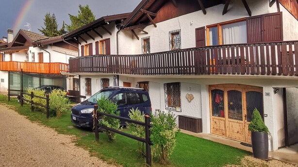 A row of traditional chalet-style buildings with wooden balconies and a car parked in front. - Casa Polsa "1964" - #02
Holiday Home in the mountains (Polsa)