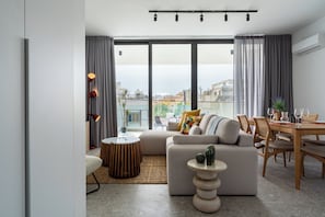 Solara 201 | Living room | 50-inch Smart TV with digital channels, Netflix, streaming services - Solara - Stylish Balcony Apartments in Larnaca (Larnaca)