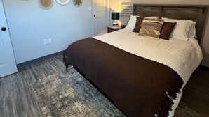 Un dormitorio con cama, ventilador de techo y decoración en las paredes.