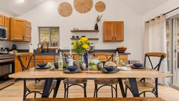 The dining table set and the kitchen steps away. Group dinners at Lakeview feel less like cooking and more like something worth remembering.