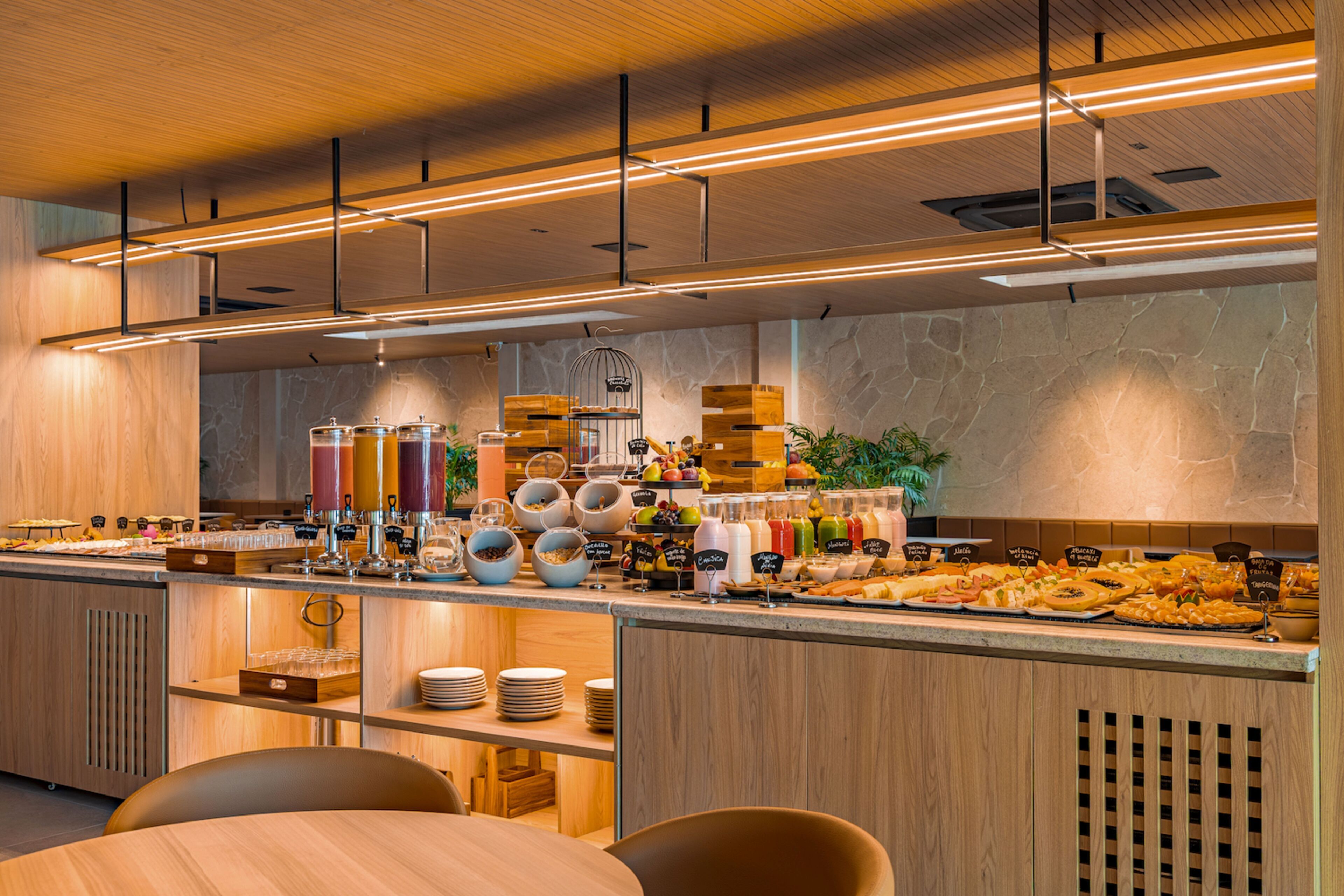 A modern breakfast buffet with a variety of food options and a clean, wooden interior.
