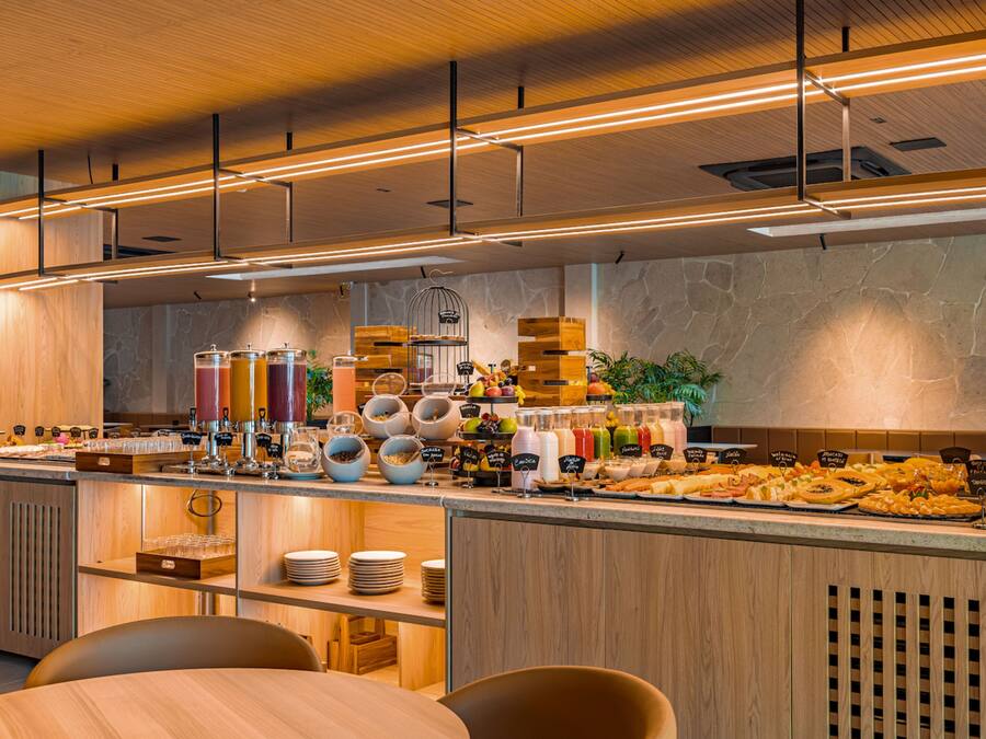 A modern breakfast buffet with a variety of food options and a clean, wooden interior.
