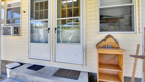 A house with two front doors, a small wooden shelf with the word "HOPE" on it, and a doormat. - Shared Lake Access & Fire Pit: Catskills Getaway! (Ellenville)
