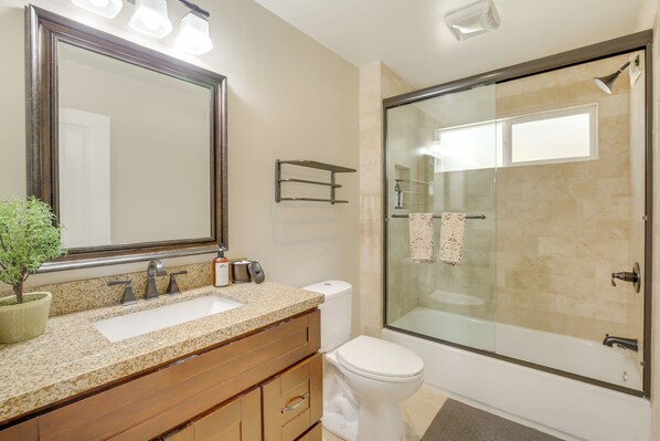 A bathroom with a large mirror, a sink, a toilet, and a glass-enclosed shower. - Walk to Lake Arrowhead Village: Gem w/ Lake Access (Lake Arrowhead)