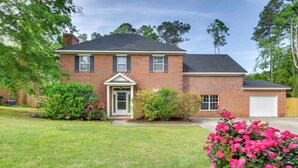 A two-story brick house with a front porch, a garage, and a well-maintained lawn. - 10 Mi to Augusta: Georgia Family Home w/ Yard (Augusta)