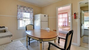 A compact kitchen with a refrigerator, sink, and dining area. - Shared Boat Launch: Lake Retreat in Ellenville! (Ellenville)