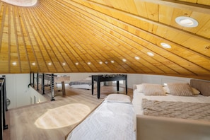 Relax in this spacious room with a comfortable bed, sofa, and small table.