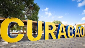 Large yellow and blue letters spelling "CURACAO" on a paved surface. - Chic City View Residence by the Bay (Willemstad)