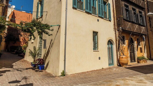 A building with a flat facade, multiple windows, and a door. - Panaretos Deluxe Maisonette (Chania)
