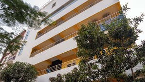 A multi-story building with balconies and a gated entrance. - Yellow Bells Signature (Hyderabad)
