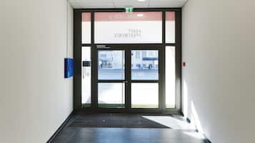 A building entrance with a sign reading 'ADVENT ENERGY' and a blue mailbox on the wall.