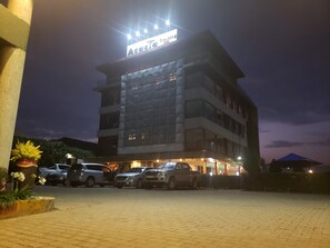 A multi-story building with a sign reading "Acacia." - Acacia country Inn (Mbarara)