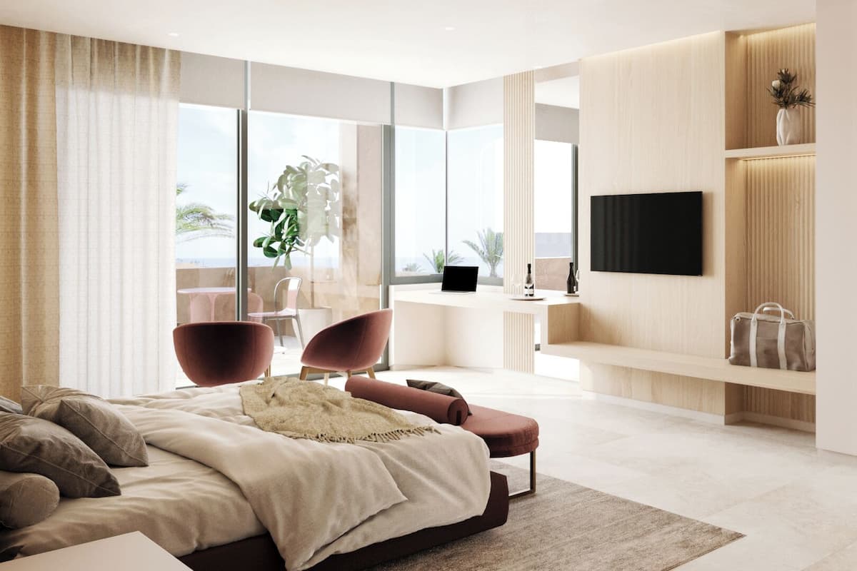 A modern bedroom with a large bed, a desk, and a TV.