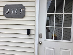A house number sign, a door with a window, and a mailbox. - Hilltop Overlook with sweeping views, private entrance.  Cozy interior (Swain)