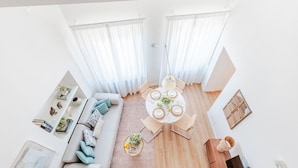 A modern living room with a round dining table, a sofa, and a coffee table. - Luxury 2 Bedrooms 2 Bathrooms Penthouse, Elevator (Lucca)