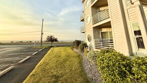 A building with a flat roof, multiple windows, and a balcony. - ⨳ Lake Erie Waterfront condo conveniently located near Jet Express - 1BR 1 BA ⨳ (Port Clinton)