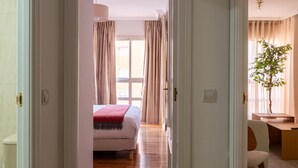 A hotel room with a bed, a desk, and a chair. - Las Tablas - 1 Bedroom with sofa bed and terrace (Madrid)
