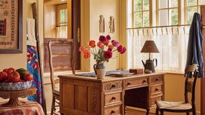 A traditional room with a wooden desk, a chair, a vase with flowers, a lamp, and a window with curtains. - Six Bells Countryside Inn (Rosendale)