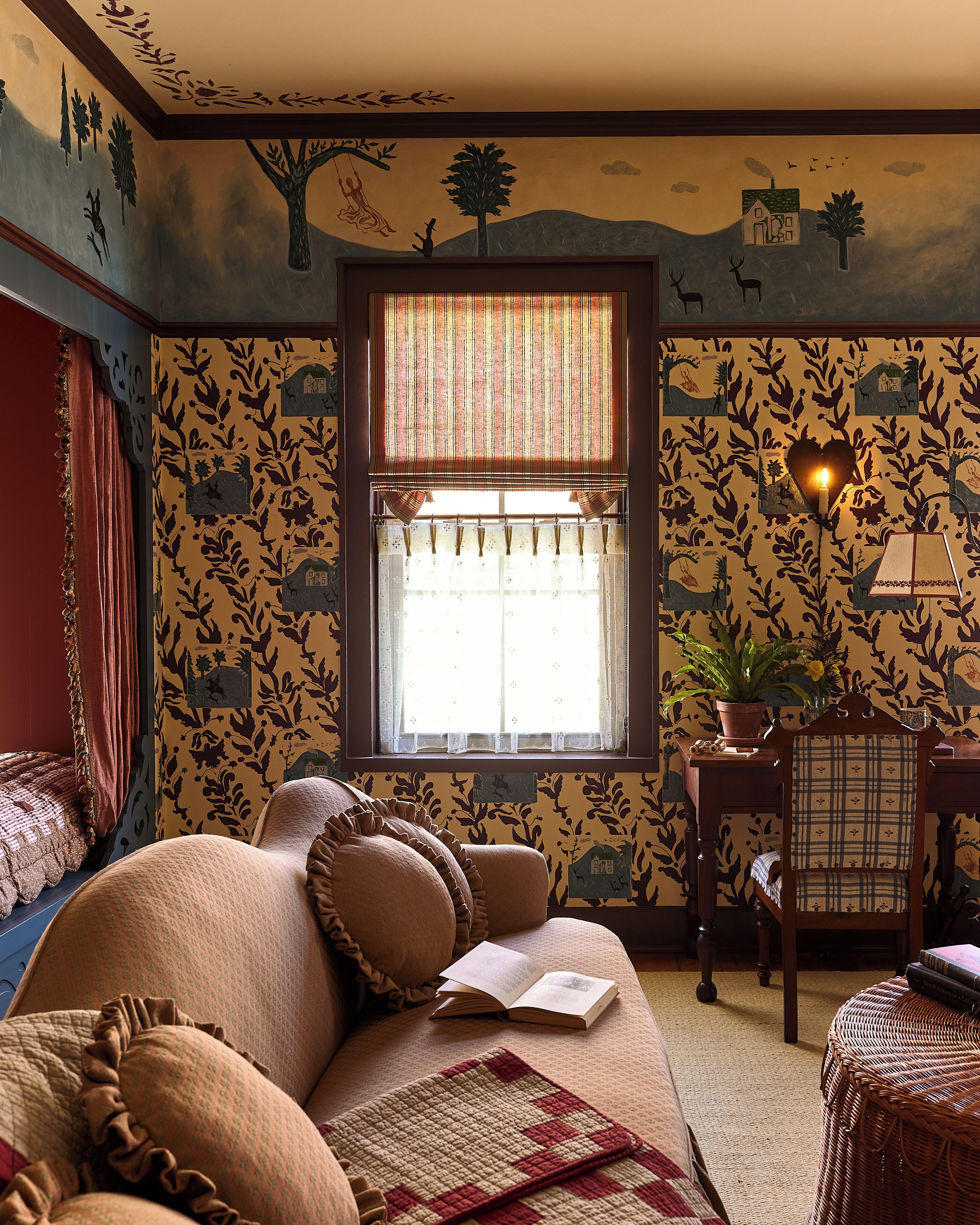 A cozy room with a large bed, a window with patterned curtains, and a wall decorated with nature-themed wallpaper.