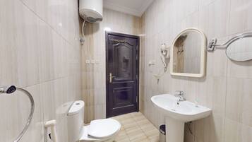 Separate bathtub and shower, towels, soap, shampoo