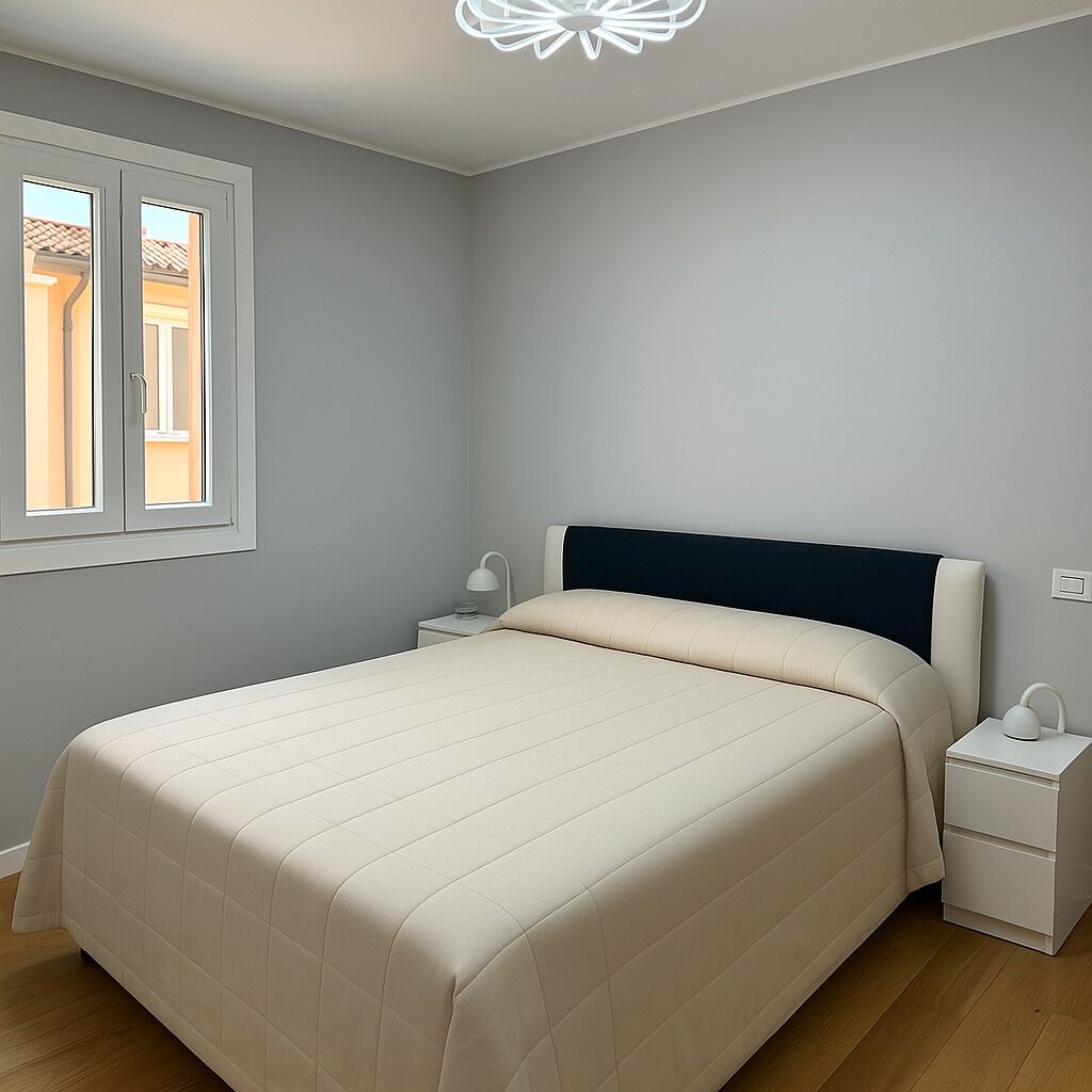 Un dormitorio con cama, mesita de noche y ventana.