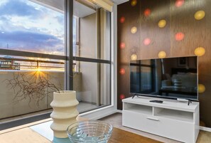 Enjoy a view of the sky from the large window, relax with the flat-screen TV, and appreciate the artistic touch of the decorative wall.