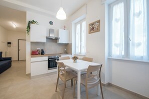 Enjoy meal preparation and dining in this well-equipped kitchen with a central island, sink, and oven.