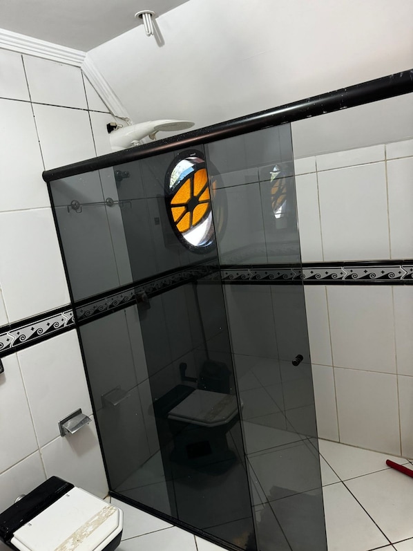 A glass-enclosed shower stall with a toilet visible through the glass. - Pousada Castelo da Villa (Foz do Iguacu)