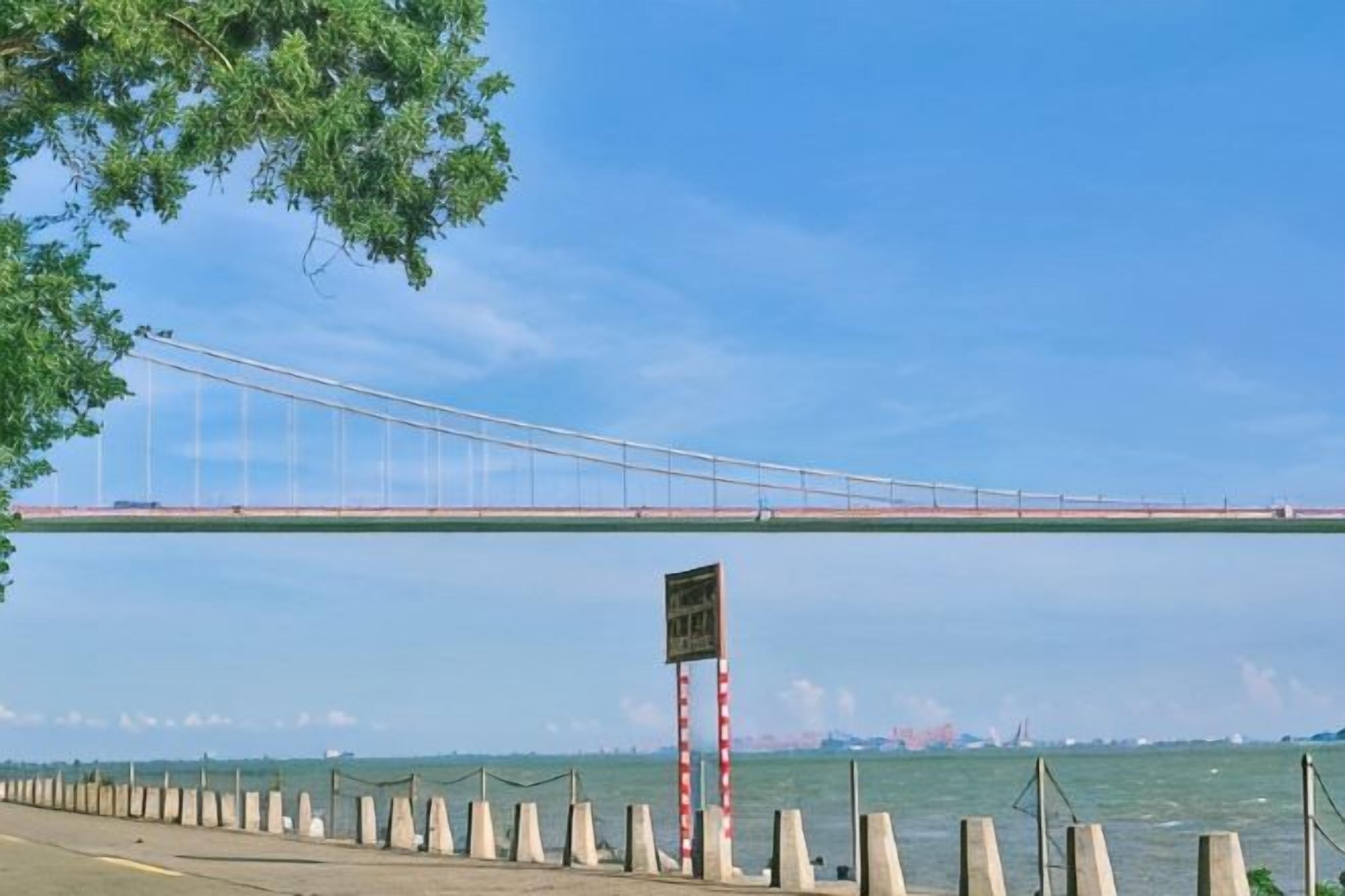 A bridge over water with a clear sky.