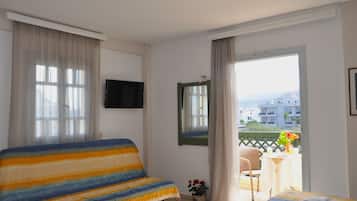 Classic Triple Room, Balcony, City View | Living area | TV