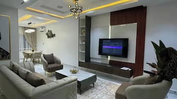 Family Apartment, Balcony, City View | Living area | Flat-screen TV