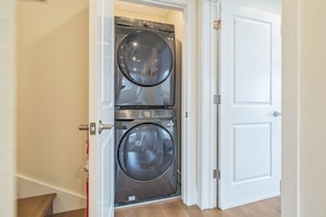 Convenient laundry facilities feature two front-loading washing machines.