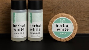 Two bottles of herbal white shampoo and one bar of herbal white soap.